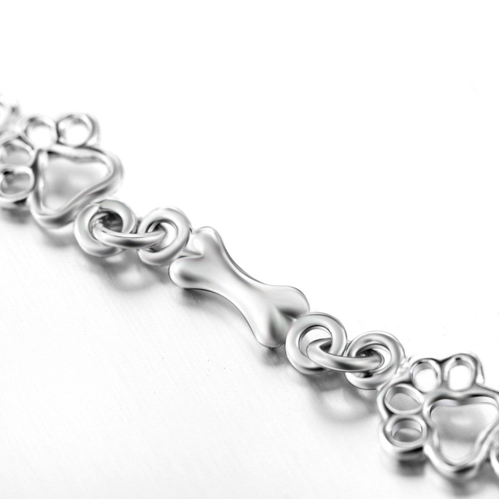 Silver Bracelet Featuring Dog Paw and Bone Charms
