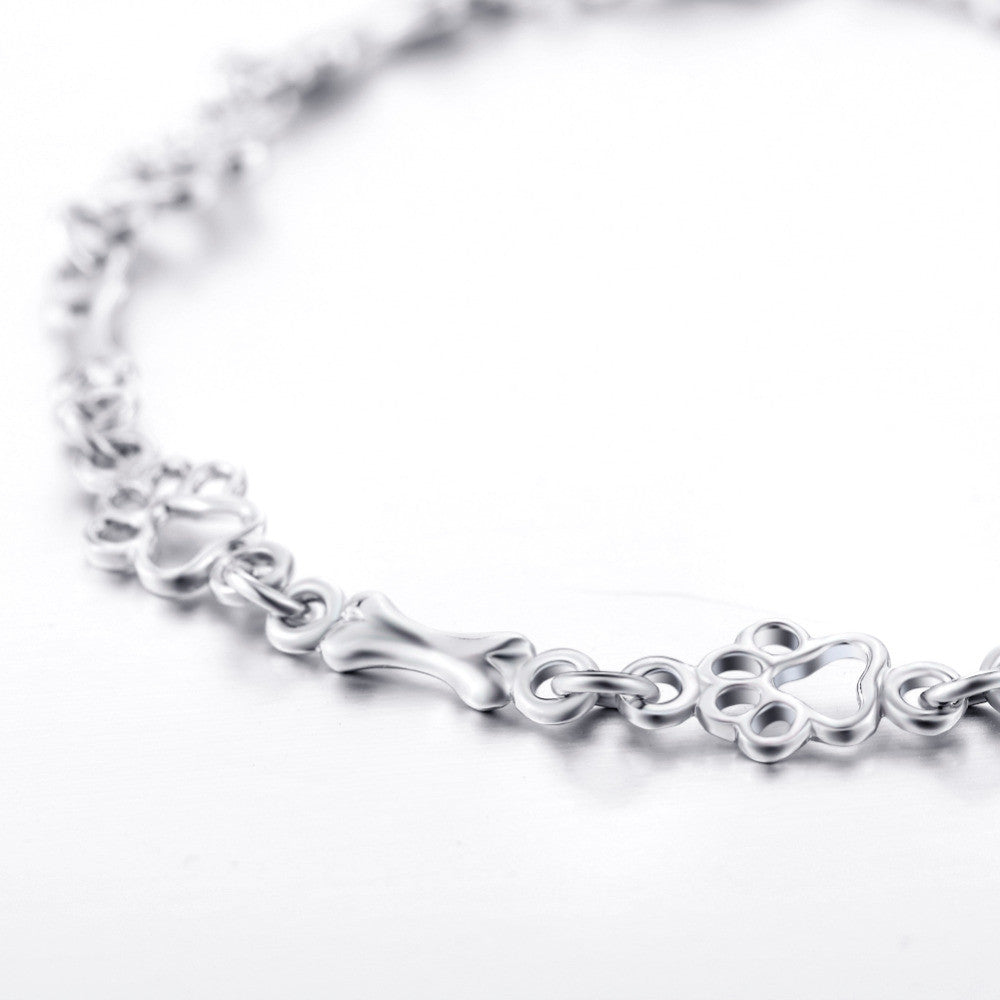Silver Bracelet Featuring Dog Paw and Bone Charms